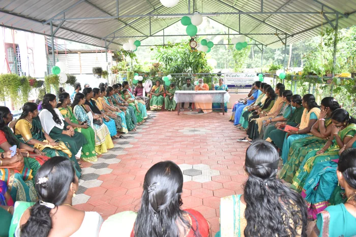 Women seated together during a community gathering